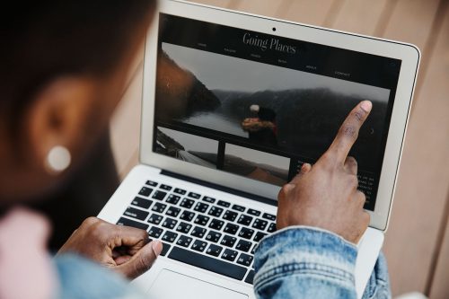 African American man working on a laptop.