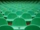 Empty green chairs in an auditorium for Target Audience page